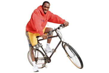 A person standing with one foot on a bicycle, ready to ride
