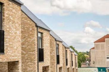 Exterior shot of a row of houses with a blue sky beyond