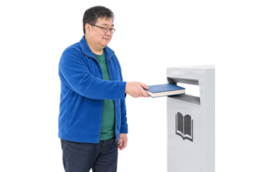 Person returning a library book using a deposit box
