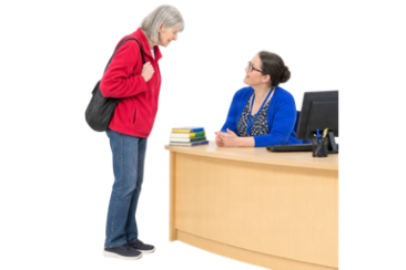 Person talking to library staff at a desk