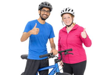 Two cyclists wearing helmets giving a thumbs-up beside a bicycle