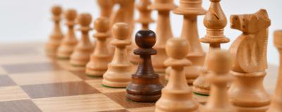 Wooden chess pieces on a chess board