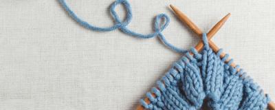 Blue wool and knitting needles