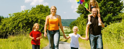 Family with children walking outdoors on a countryside path