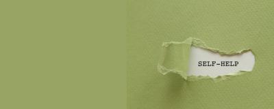 Paper with a torn out piece saying self-help