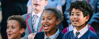 Students singing in a crowd.