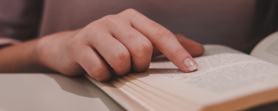 a hand on a book