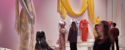 a woman looking at a manniquin