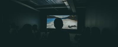 A person sitting in a dark cinema