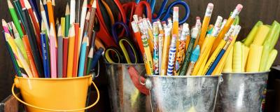 Colourful pencils in tin pots