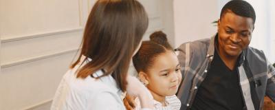 a man and a woman sitting next to a child