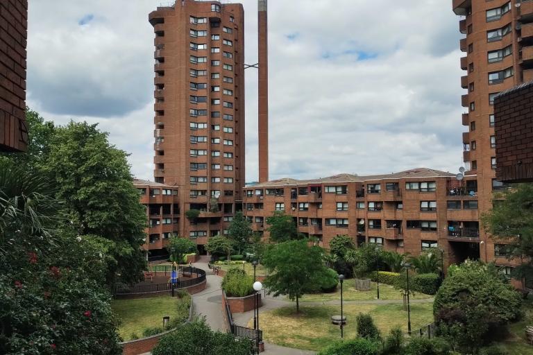 a view of the central shared garden on the worlds end estate. a green area surrounded by brick tower blocks