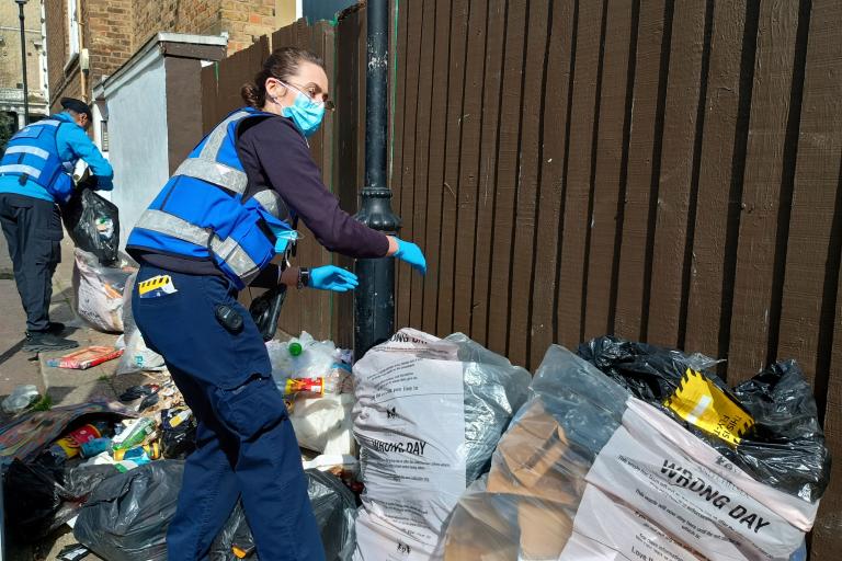 Two street enforcement officers investigating a fly tip