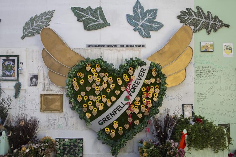 A memorial at the base of Grenfell Tower