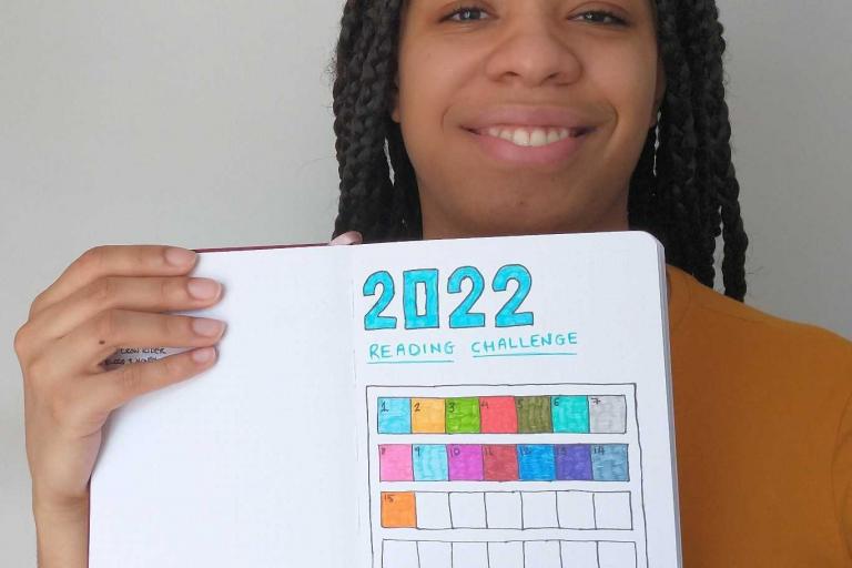 Keira holds up her book journal
