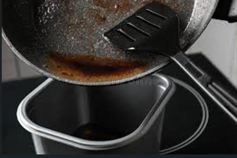 metal saucepan tipping cooked grease into a container with a spatular guiding it 