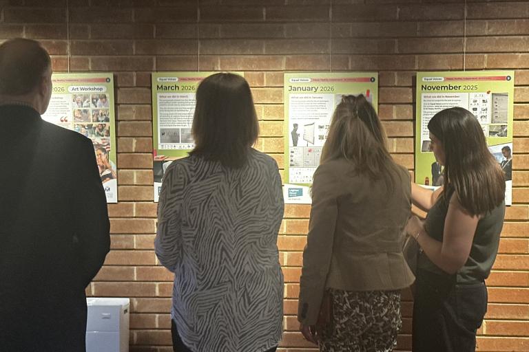 Visitors look at artwork in the SEND Equal Voices exhibition