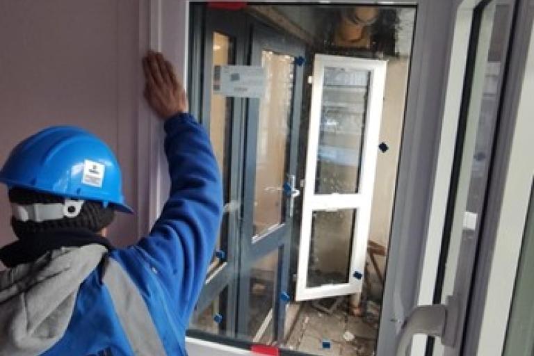 Builder inspecting a window installation