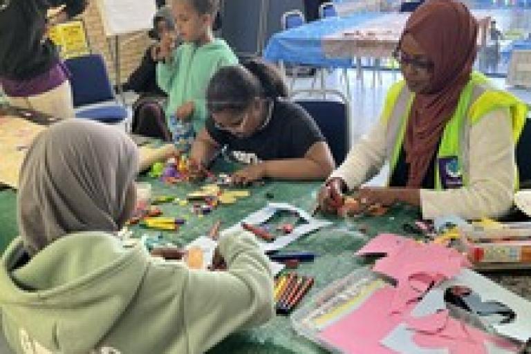 Children at a table doing arts and crafts