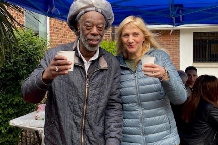 a man and a woman enjoy a beverage under a marquee
