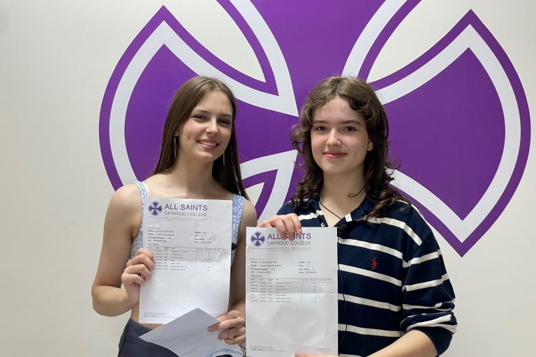 Two pupils show off their GCSE results