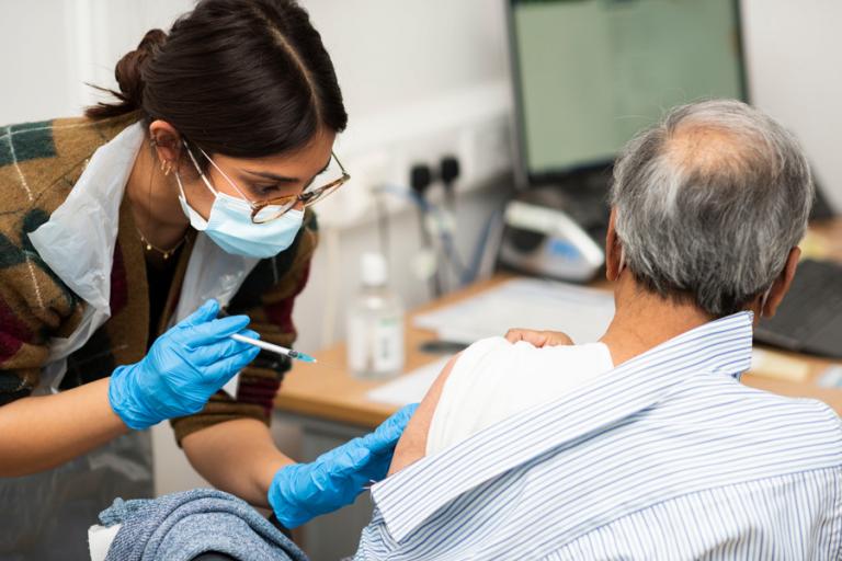 A covid vaccination is administered