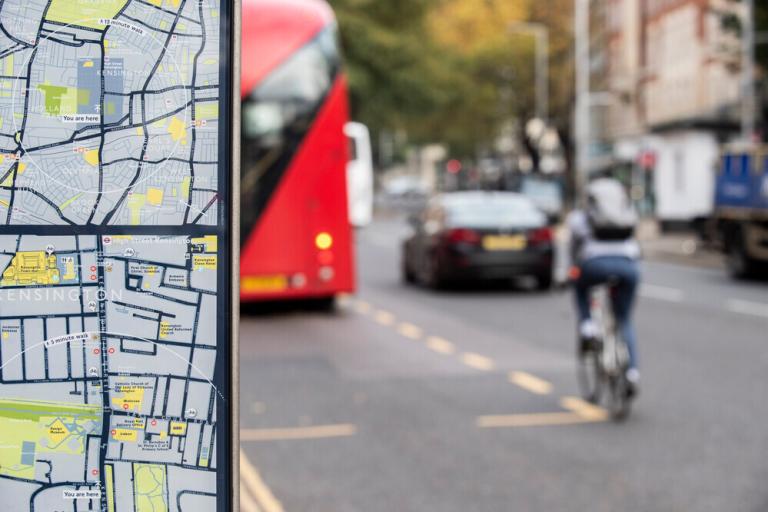 Person cycling and map in foreground