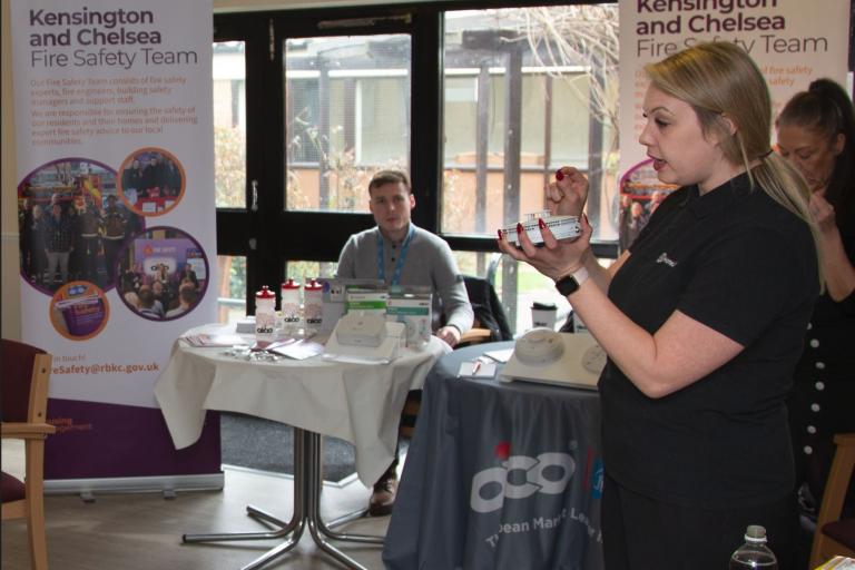 residents of sheltered housing listening to the building safety manager talking about smoke and fire alarms 