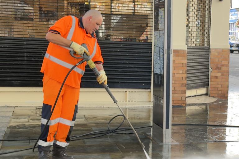 A Suez worker clears up during Carnival 2026