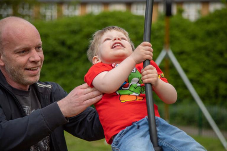 Father and son playing on playground