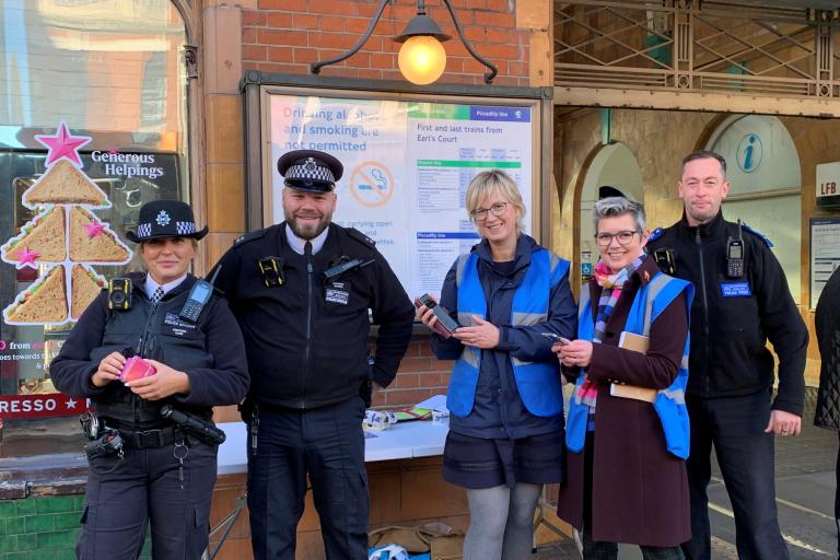 Three police officers and two members of community safety team outside Earl's Court station