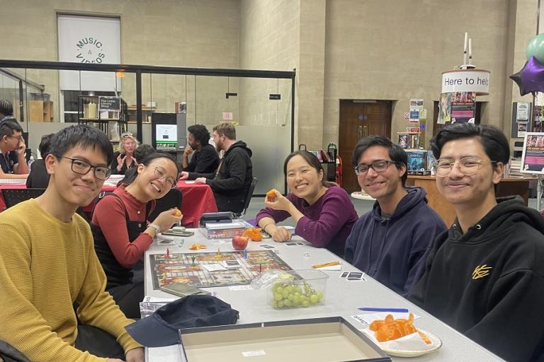 a group of people playing a board game in the library