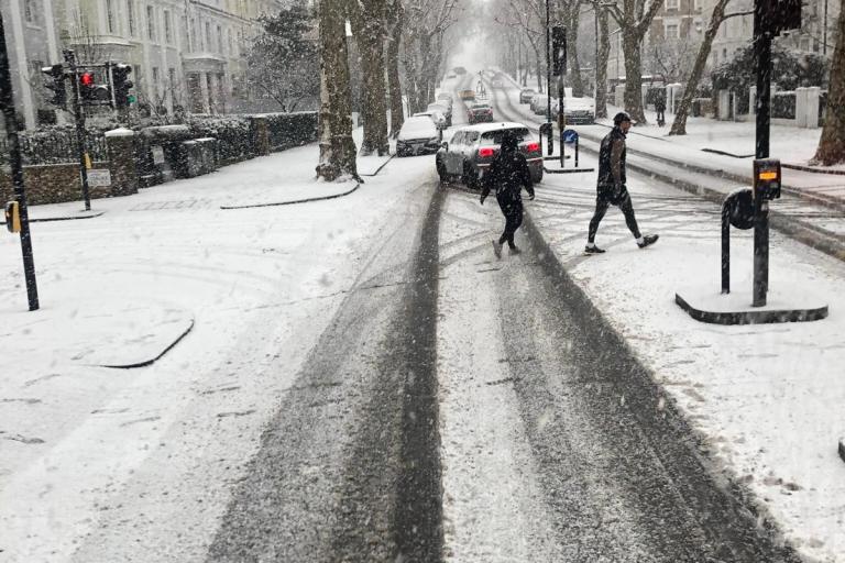 Looking out of a window at snow on Holland Park Avenue
