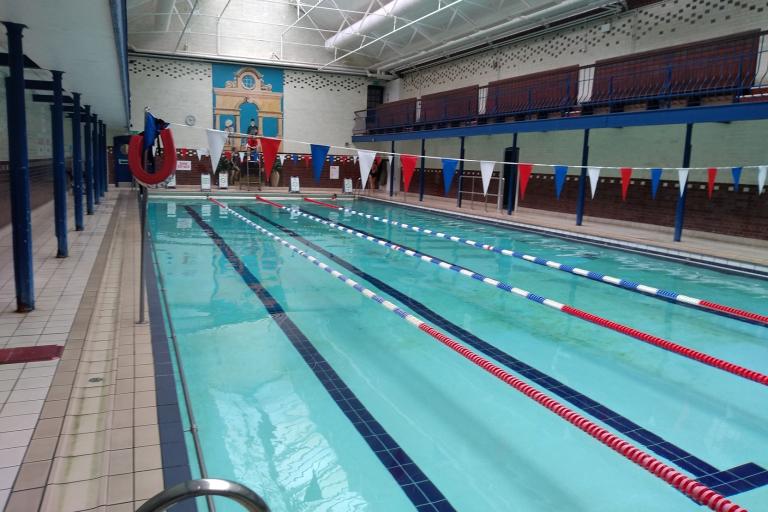 A photograph of an indoor swimming pool