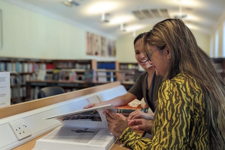 Two women browsing books in one of the borough's libraries