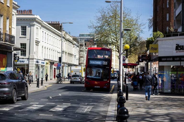 King's Road with shops on either side a bus driving down the road