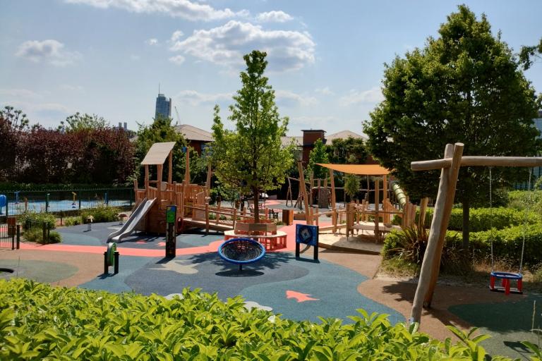 Distance view of KMP playground, including climbing frame, slide and swing