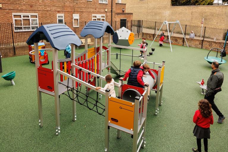 Children play on a range of play equipment