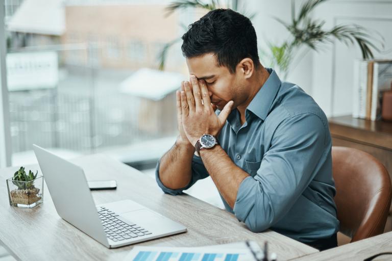 Man with head in hands thinking