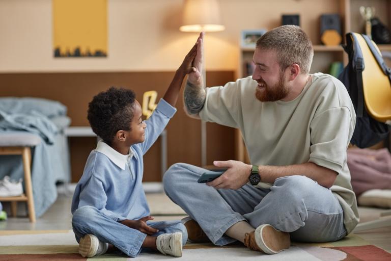 A social worker high fives a child