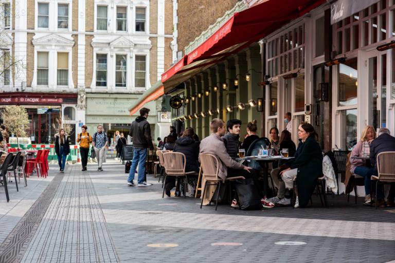 A pedestrianised street with outside dining and restaurants.