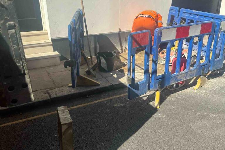 Image of a man carrying out works with barriers