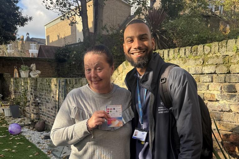 Competition winner, Tracey, shows off her voucher, accompanied by Aaron, the visiting officer