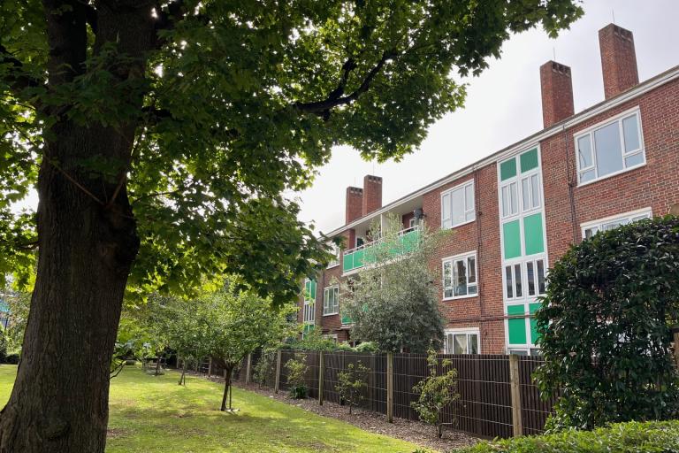 Low rise apartment block with green panelling