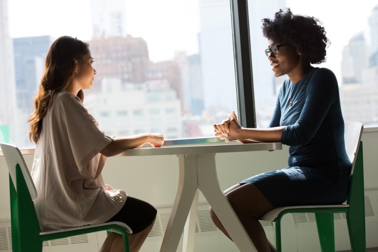 Two people having a discussion at a table