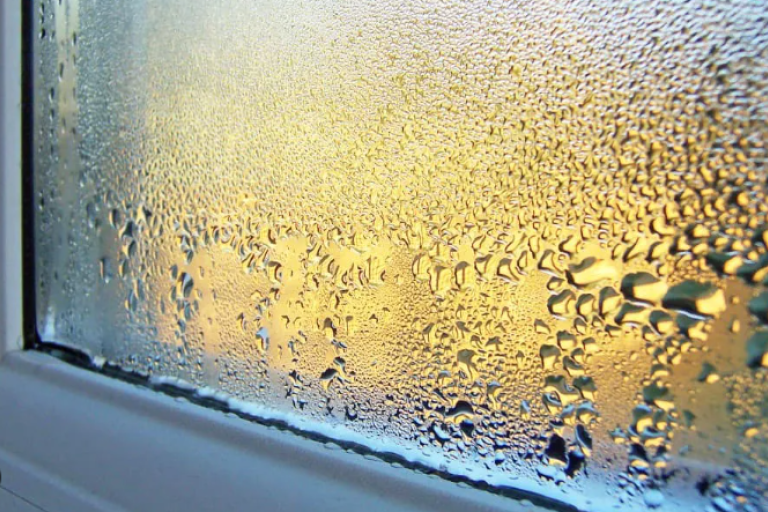 white pvc window sil with condensation droplets. Damp and mould. condensation. prevention. 