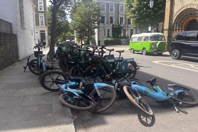 A rack of ebikes fallen over on a street
