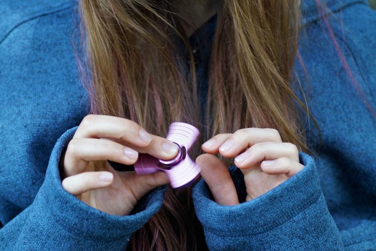 Girl uses fidget spinner