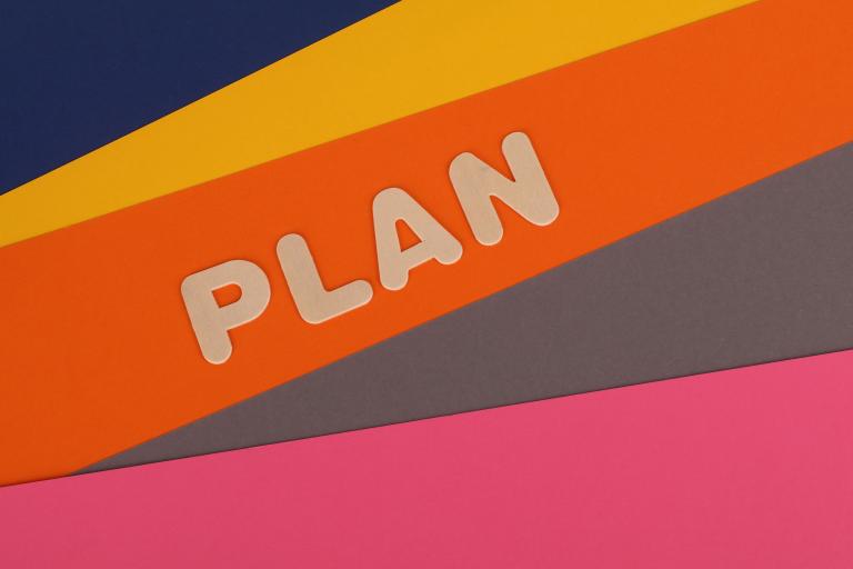 The word plan on a coloured background