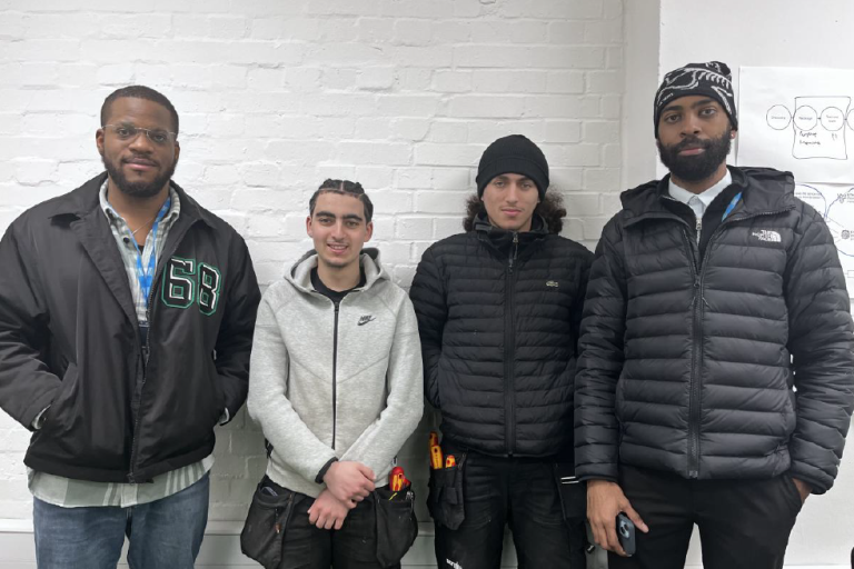 4 men standing next to eachother 